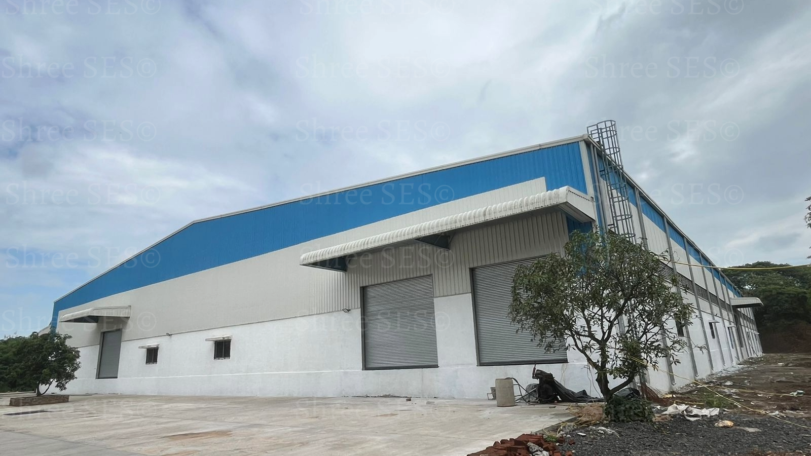 Completed 100,000 sq ft PEB warehouse shed near Surat, showcasing zero-error steel erection and 100% structural integrity.