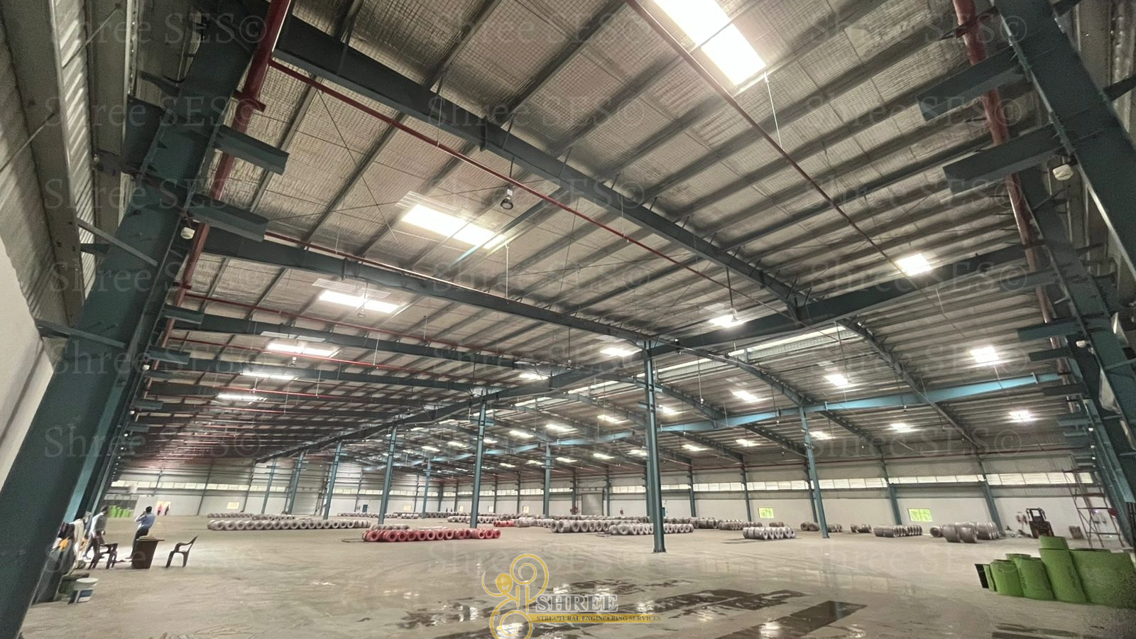Inside view of a massive 100,000 sq ft Pre-Engineered Building (PEB) utilizing a stable BC-2 module design for heavy industrial application.