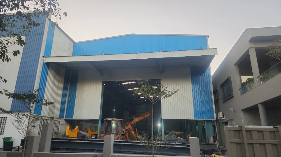 High-quality PEB design for industrial sheds and factories showcasing structural steel frames and roofing