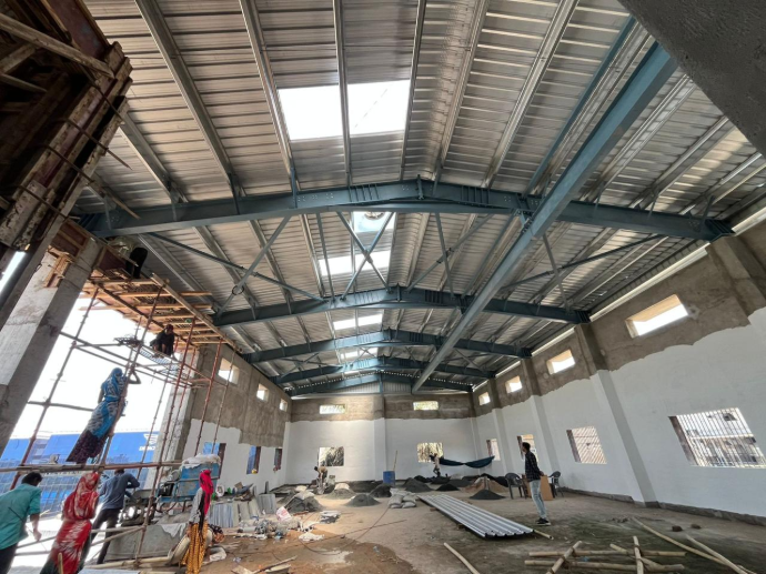 Internal structural framing of a heavy-duty industrial shed, showcasing precision engineering and robust rafter connections for superior stability - detailed peb design shreeses