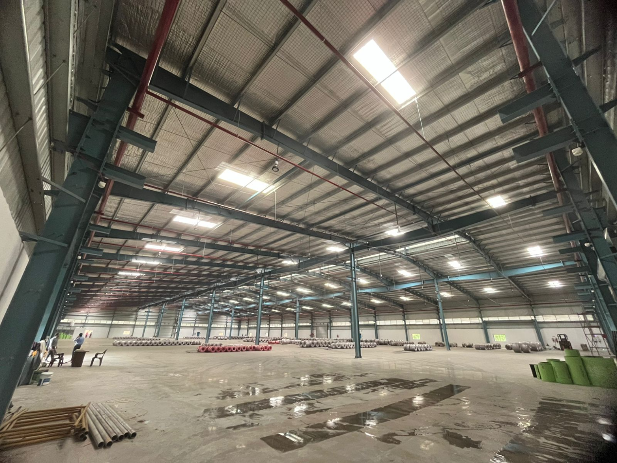 detailed peb design - Massive indoor warehouse storage space with fire safety piping and wide-span steel columns - Designed at ShreeSES