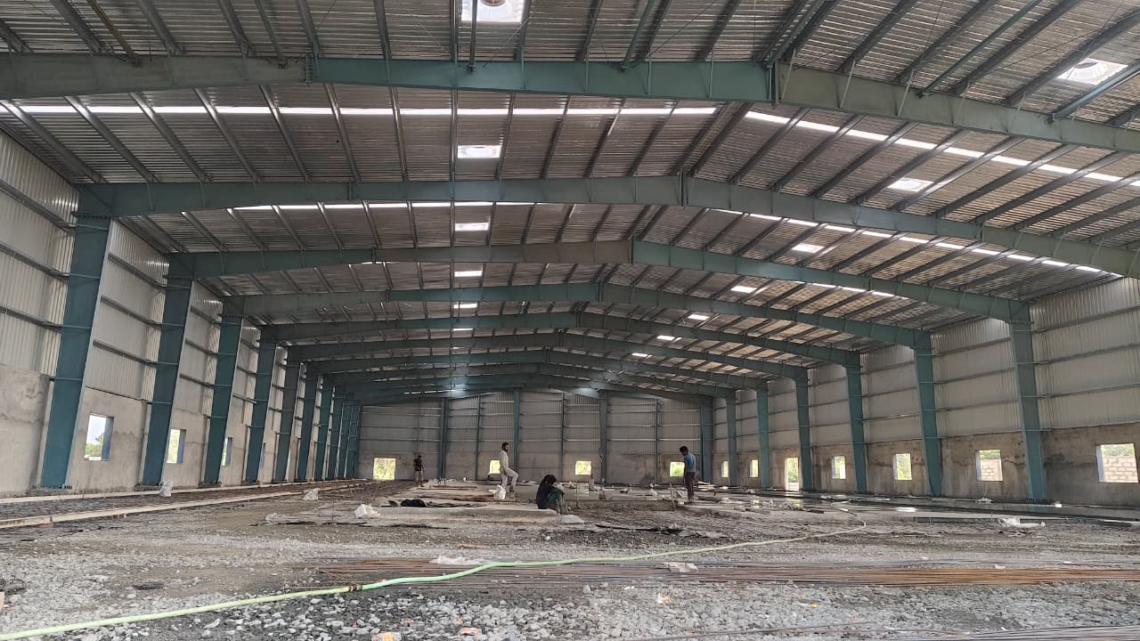 multi-span pre-engineered building interior featuring optimized steel portal frames and polycarbonate skylights for industrial warehouse design.