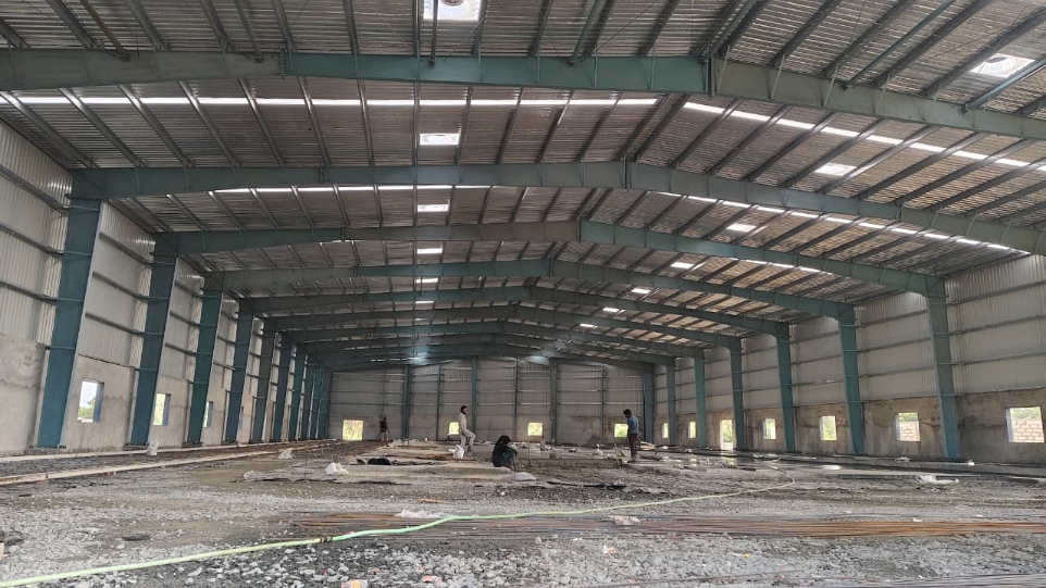 Internal structural framing of a heavy-duty industrial shed, showcasing precision engineering and robust rafter connections for superior stability - detailed peb design shreeses